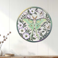 Floral moth wall sign displayed on white paneled decor, bringing soft botanical style to a living space