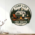 Camping metal sign displayed on a white paneled wall above a console, featuring an RV and mountain camp scene