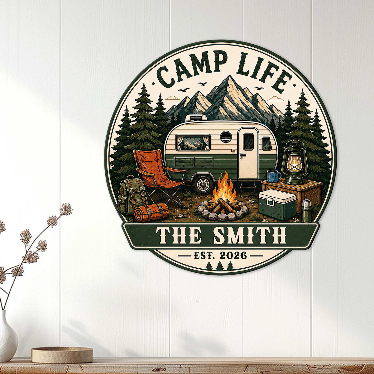 Camping metal sign displayed on a white paneled wall above a console, featuring an RV and mountain camp scene