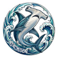Illustrated shark metal sign surrounded by curling ocean waves in blue and teal tones