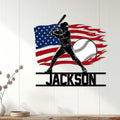 Patriotic baseball wall sign displayed on white paneling with a batter, baseball, and flag design