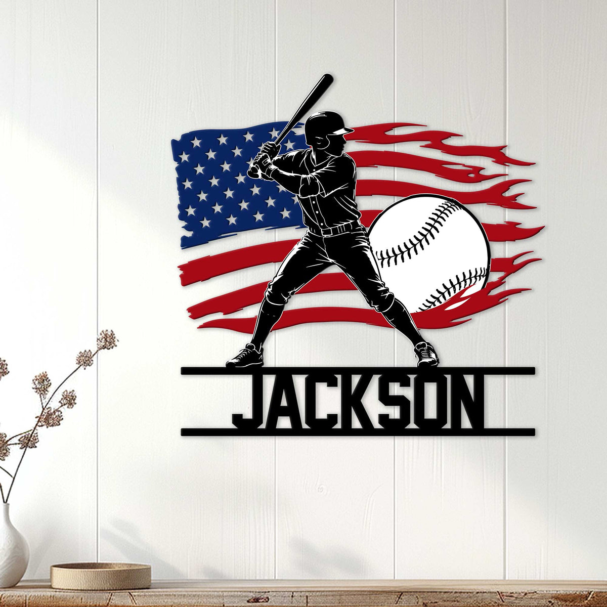 Patriotic baseball wall sign displayed on white paneling with a batter, baseball, and flag design