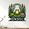 Frog pond wall decor displayed on a light wood-paneled wall in a cozy room
