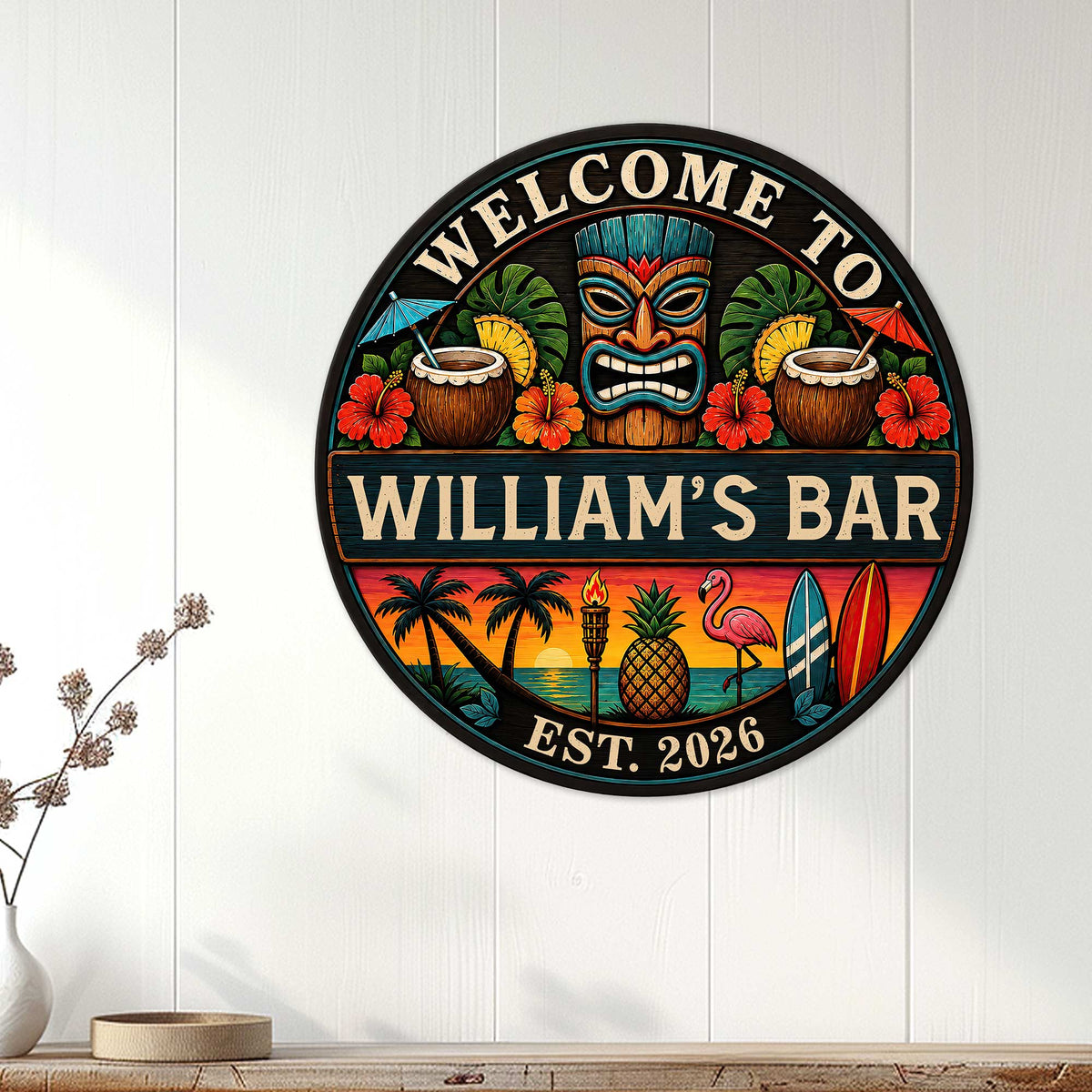 Tiki bar wall decor displayed on a white paneled wall with tropical mask, cocktails, and island sunset artwork