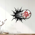 Baseball wall decor displayed on a light wood-paneled wall in a home interior