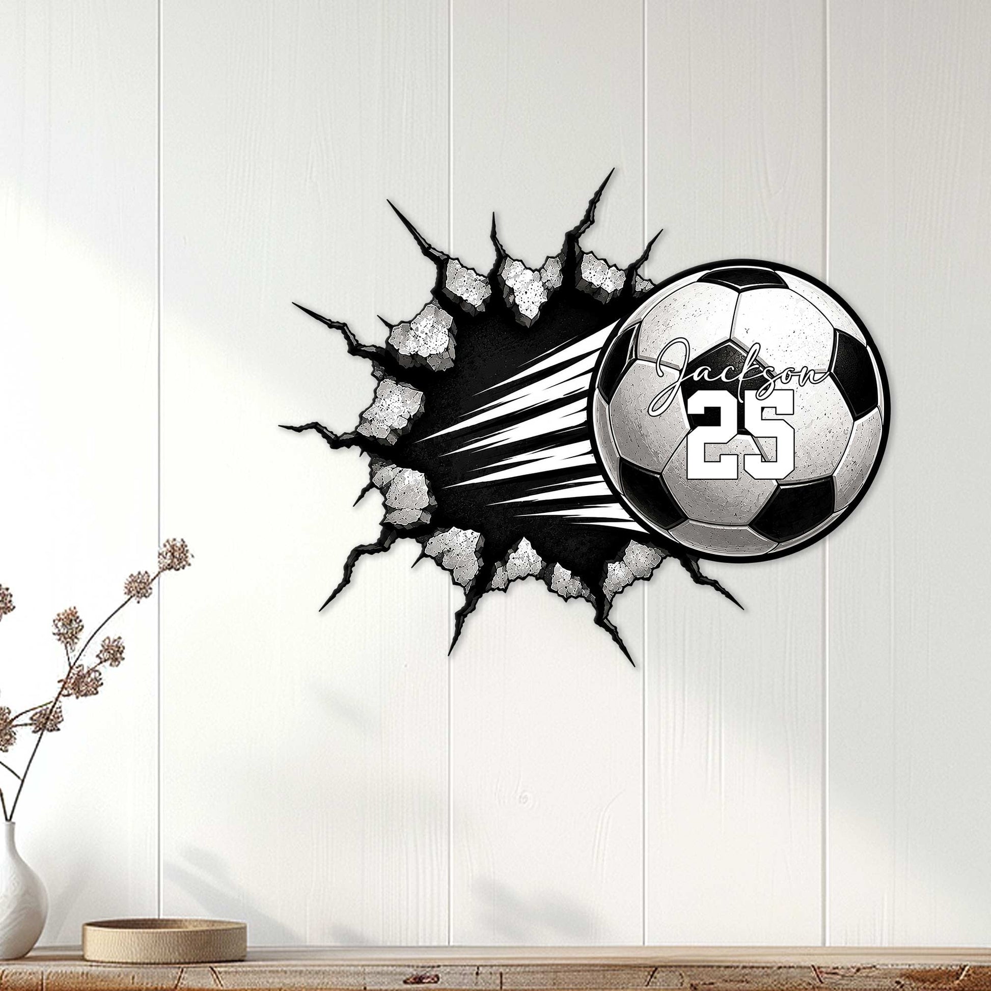 Soccer metal wall sign displayed on white paneling, featuring a ball bursting through a cracked surface