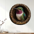 Round hummingbird metal sign displayed on a white paneled wall in a bright home interior