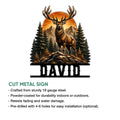 Cut metal hunting sign showcasing a detailed deer standing among evergreen trees, rocks, and mountain peaks