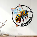 Bumblebee metal wall sign displayed on a light wood-paneled wall in a bright home decor setting