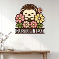 Floral hedgehog wall sign displayed on white paneling above a wooden console table