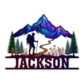 Colorful custom hiking metal sign featuring a mountain range, pine trees, winding trail, and hiker silhouette