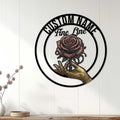 Tattoo studio wall decor featuring a rose held in a tattooed hand against white paneled walls