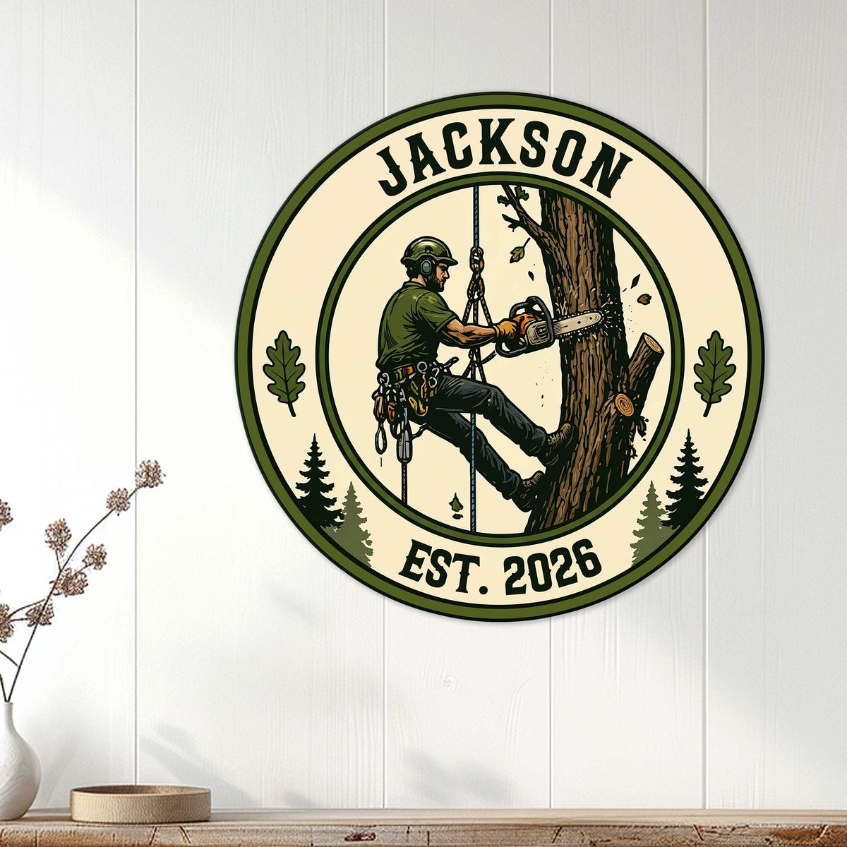 Arborist wall sign displayed on white wood paneling with a tree climber cutting a large trunk