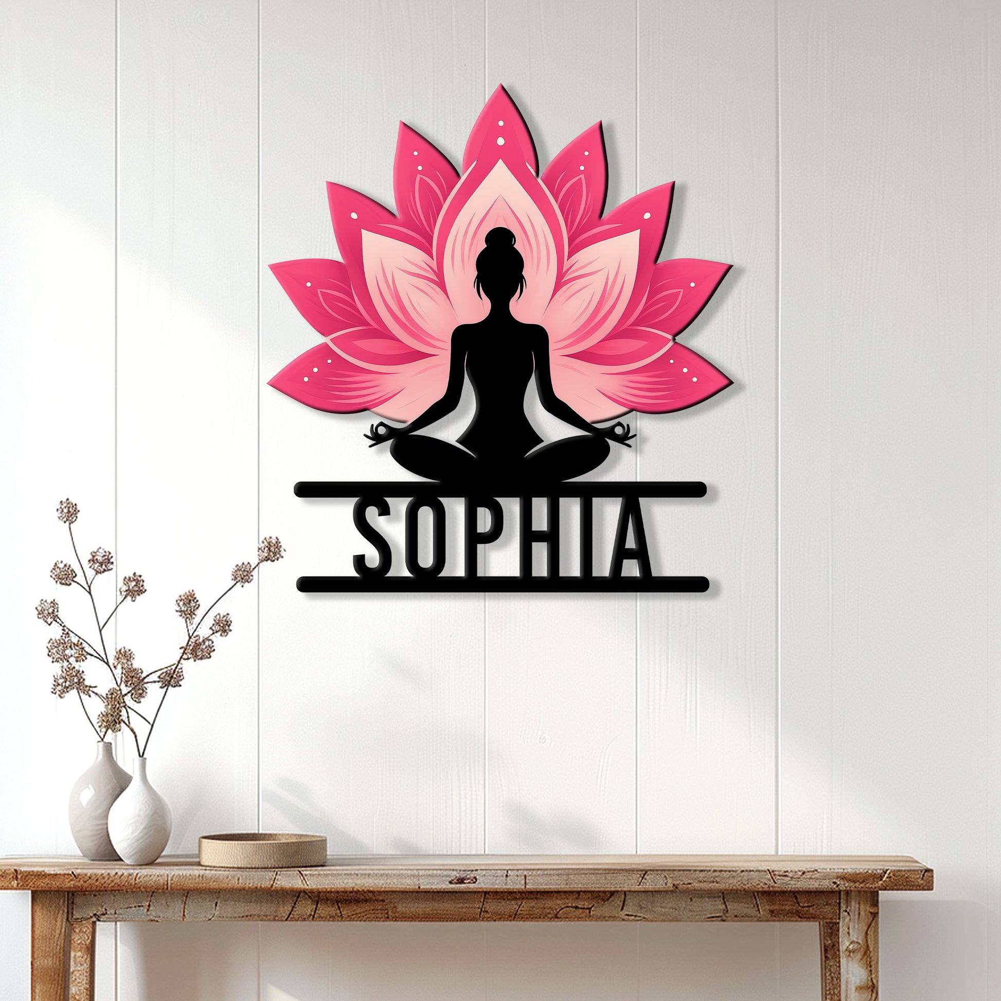 Pink lotus and meditating figure yoga wall sign displayed above a console table in a bright home
