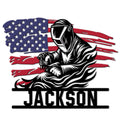 Welder metal sign featuring a welding helmet, torch, and distressed American flag