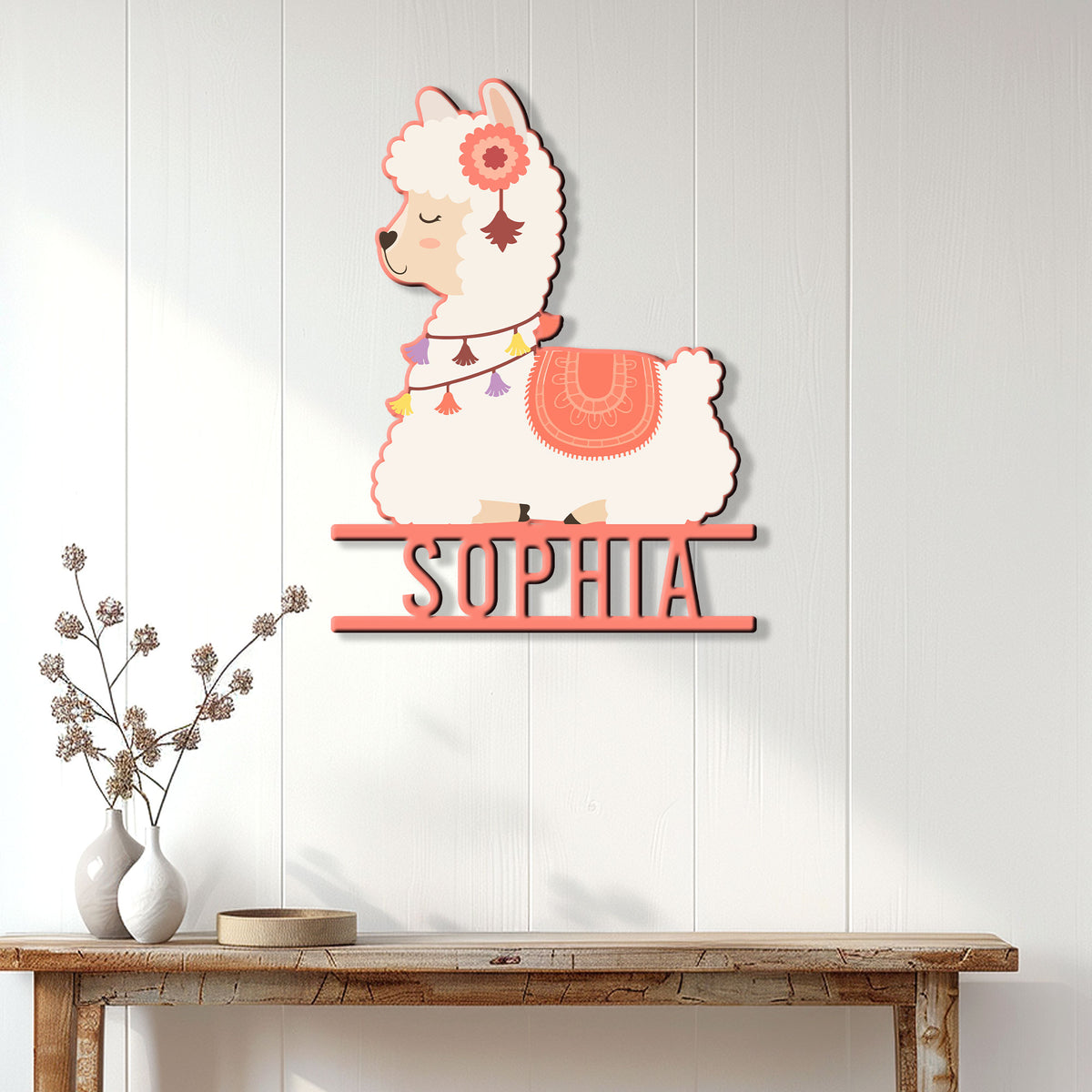 Cute alpaca wall sign displayed above a console table in a bright, neutral home interior