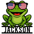 Colorful frog metal sign featuring a smiling frog in American flag sunglasses