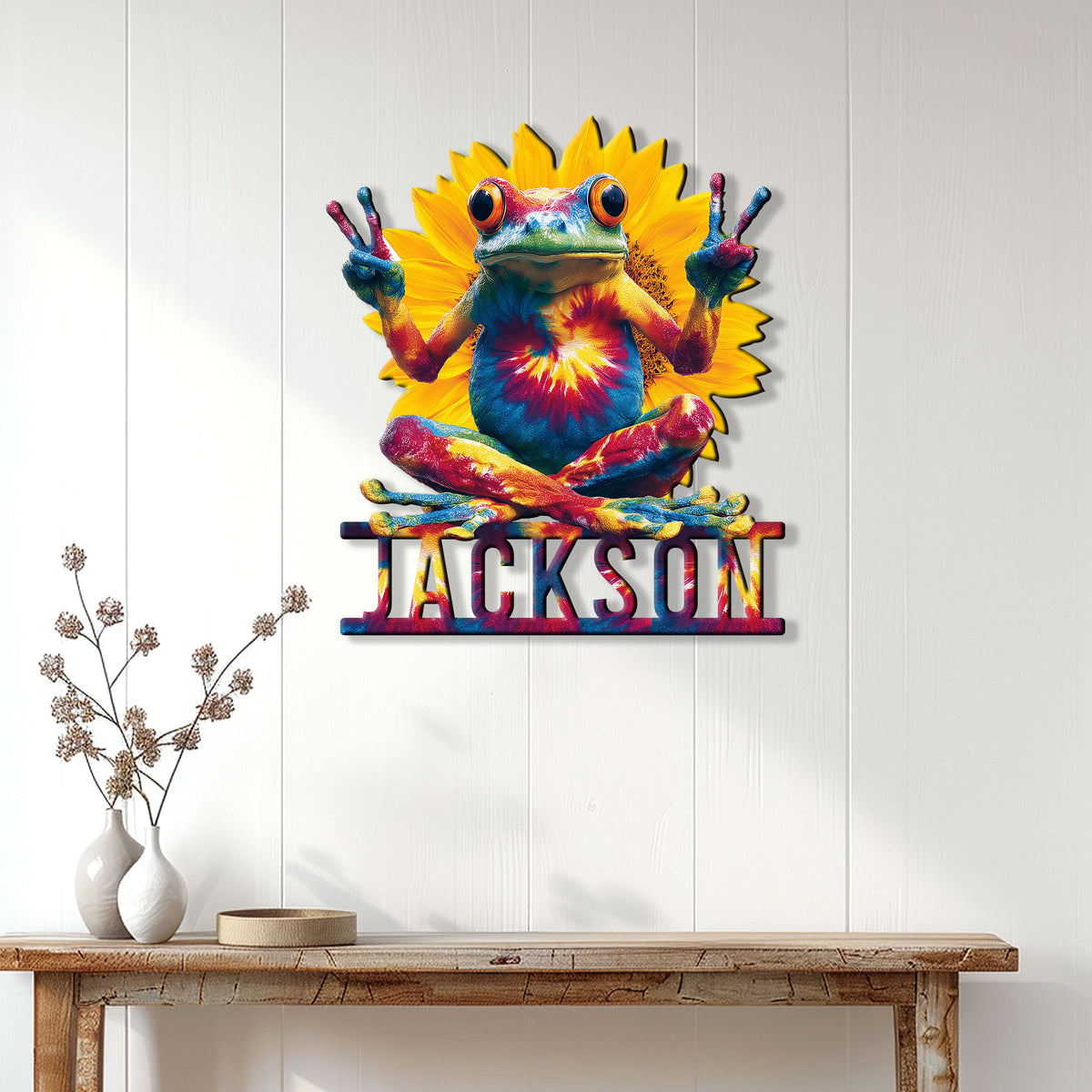 Colorful frog wall sign displayed on a bright paneled wall above a rustic console table