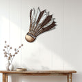 Badminton shuttlecock wall sign displayed above a console table in a bright modern home