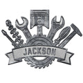 Silver-tone mechanic metal sign featuring a piston, hand tools, gear, and industrial workshop design