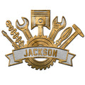 Gold-tone mechanic metal sign with a piston, wrenches, tools, gear, and rugged workshop styling