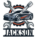Custom mechanic metal sign featuring a sporty car, crossed wrenches, screwdriver, and gear emblem