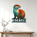 Geometric otter metal wall sign displayed on a bright paneled wall above a console table
