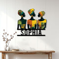 African women silhouette wall sign displayed above a console table in a bright modern entryway