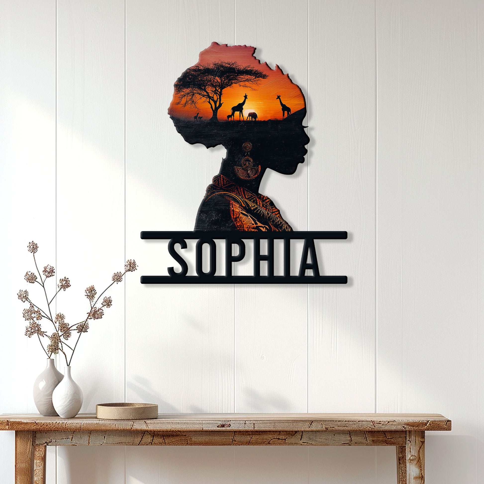 African woman silhouette wall sign displayed on a bright paneled wall above a wooden console table