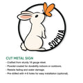 Cut metal rabbit sign showing a seated bunny and butterfly in a circular design