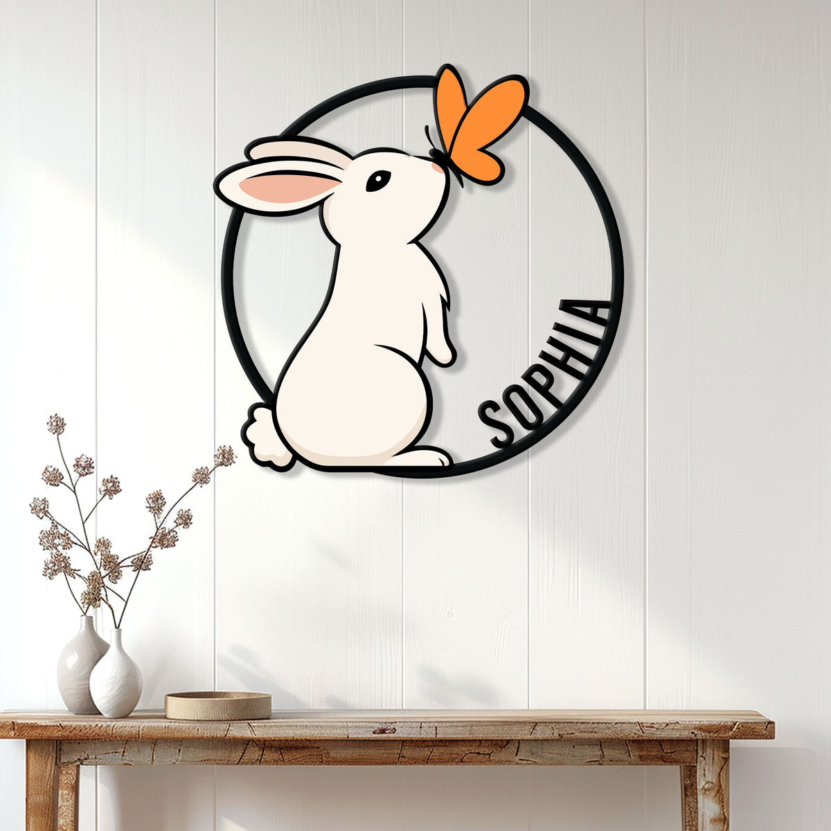 Rabbit wall sign displayed above a console table in a bright, modern home