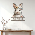Floral bunny metal wall sign displayed on a light paneled wall above a rustic console table