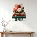 Book-themed metal wall sign displayed above a console table in a bright reading-inspired room