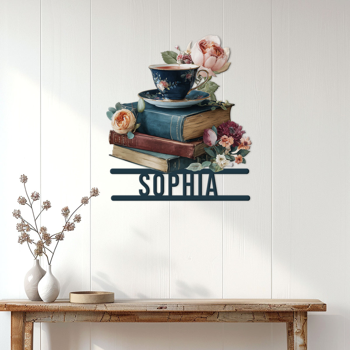 Book lover wall decor displayed above a console table, featuring stacked books, tea, and flowers
