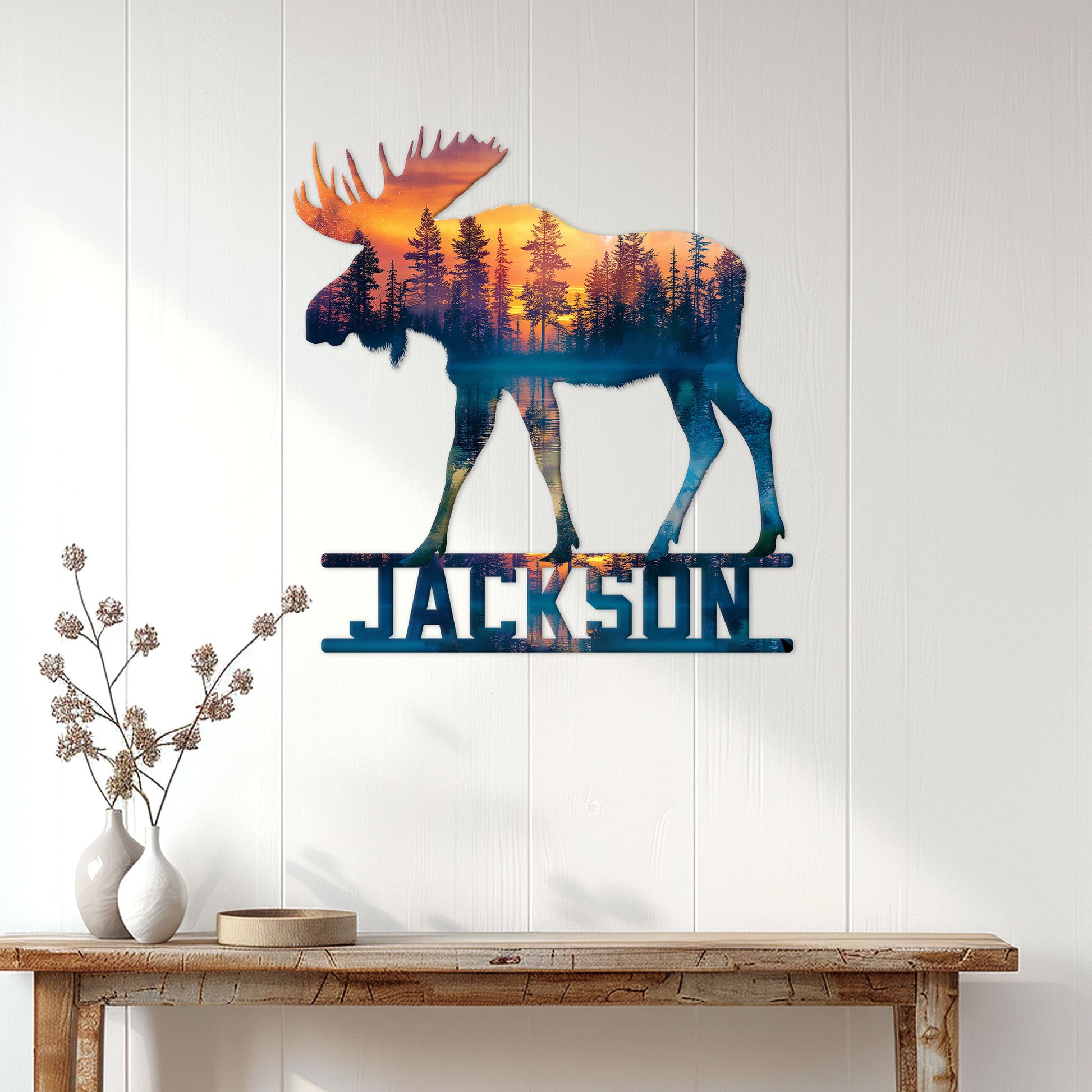 Moose wall sign displayed on a white paneled wall above a rustic console table