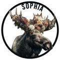 Floral moose metal sign featuring a detailed wildlife portrait with flower-filled antlers in a round frame