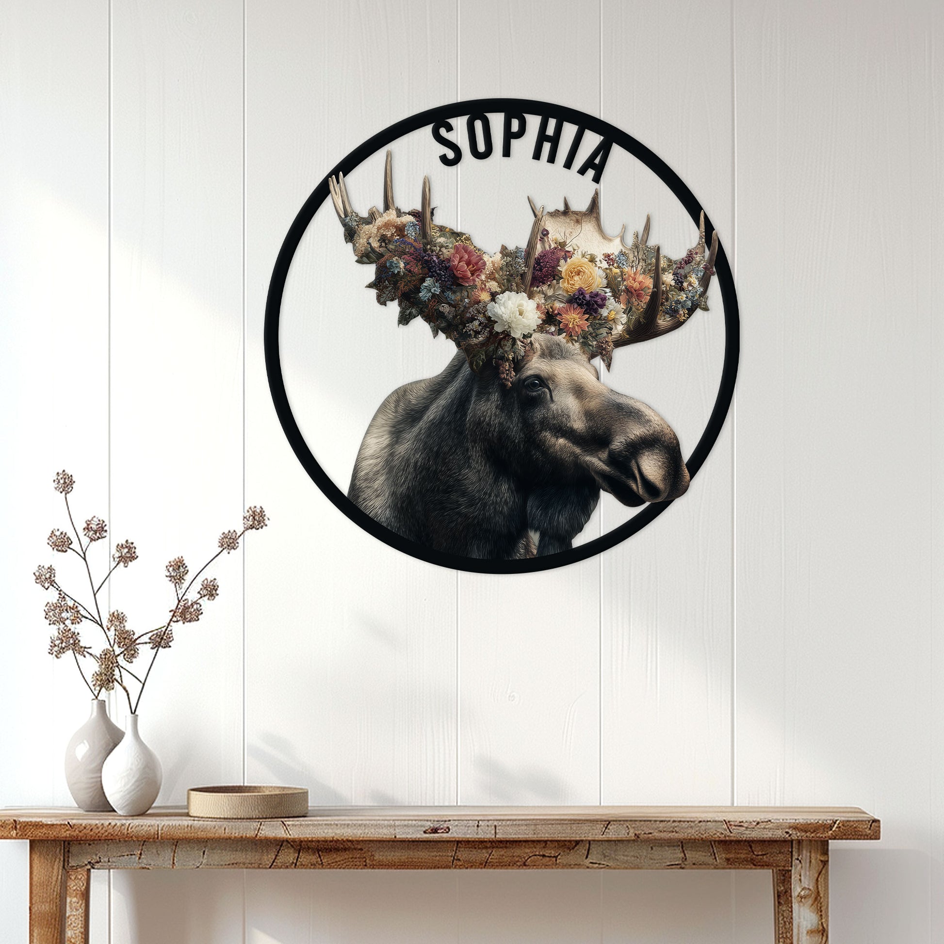 Floral moose wall sign displayed above a rustic console table in a bright home entryway