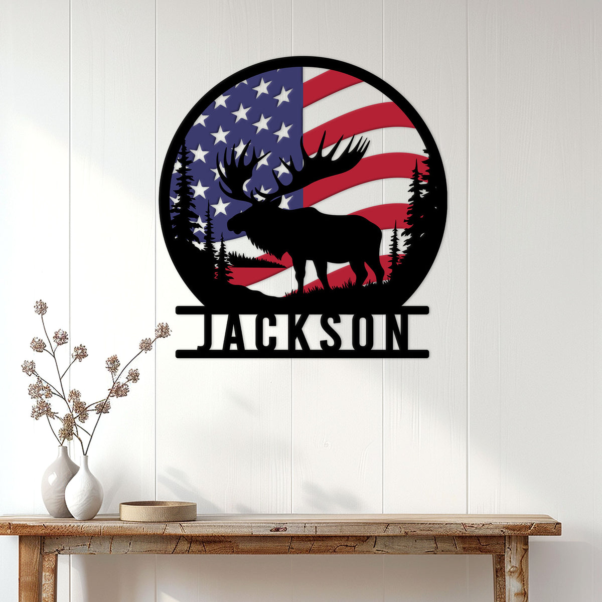 Moose wall sign displayed on a white wood wall above a rustic console table