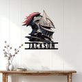Custom knight helmet metal sign displayed on a light paneled wall above a wood console table