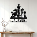 Chess wall decor displayed above a console table, featuring a dramatic arrangement of classic chess pieces