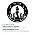 Black and white cut metal chess sign with a king and pawns in a celestial circular design
