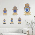 Hamsa evil eye metal sign shown in multiple size options on a light living room wall