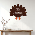 Thanksgiving turkey metal sign displayed on a white paneled wall above a rustic entryway table