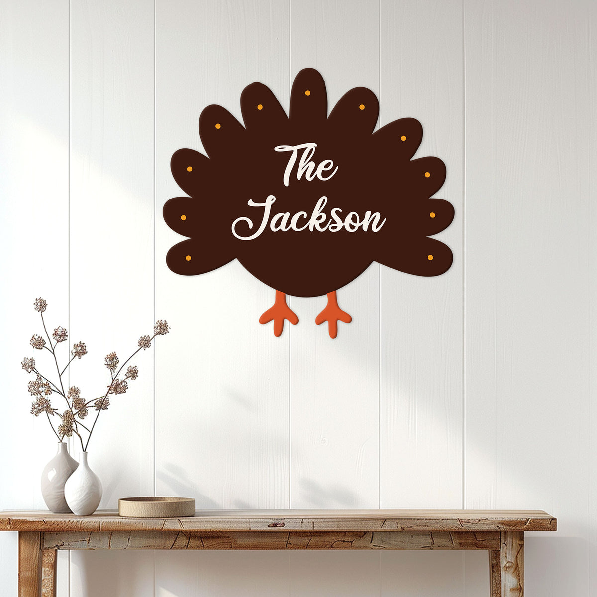 Thanksgiving turkey metal sign displayed on a white paneled wall above a rustic entryway table