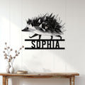 Black and white geometric hedgehog wall sign displayed on a bright paneled entryway wall