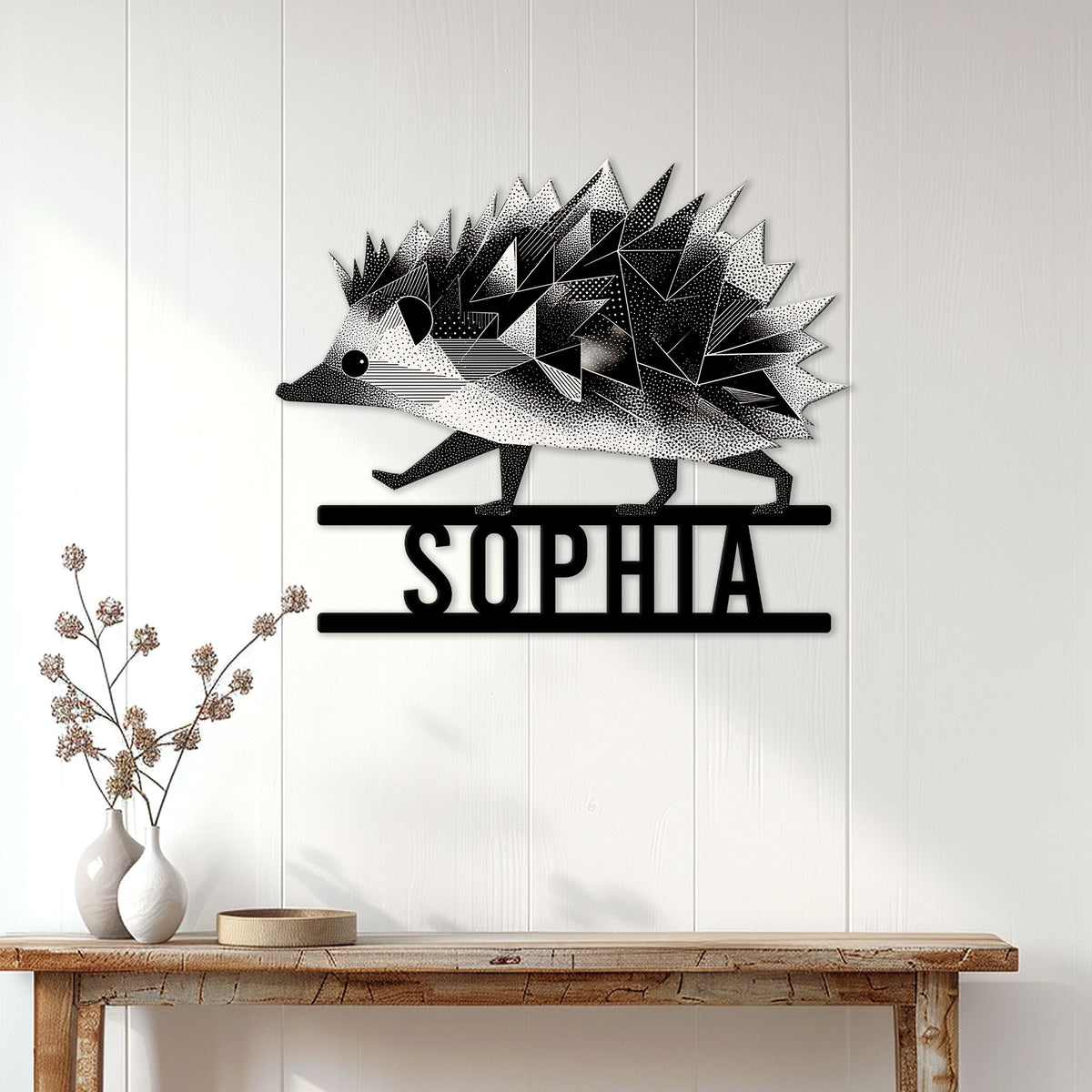 Black and white geometric hedgehog wall sign displayed on a bright paneled entryway wall
