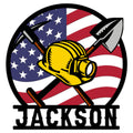 Custom miner metal sign featuring a yellow hard hat, crossed mining tools, and an American flag backdrop