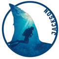 Scuba diving metal sign with a silhouetted diver exploring a blue underwater scene inside a round frame