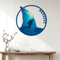 Scuba diving wall sign displayed above a console table in a bright coastal-style room