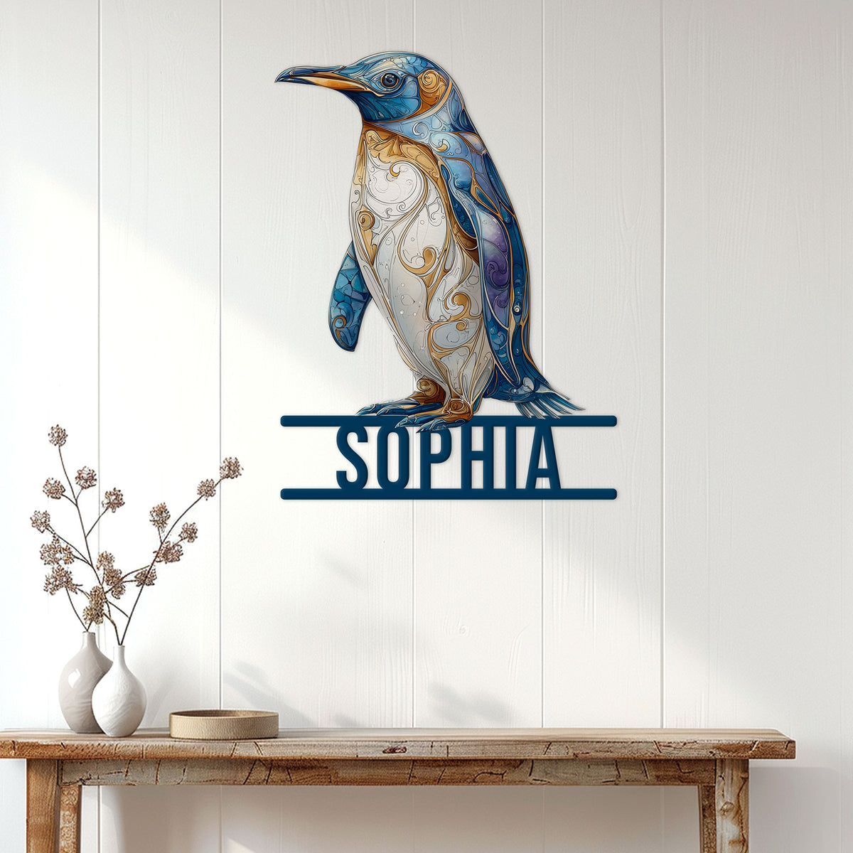 Ornate blue penguin metal wall sign displayed above a console table in a bright home entryway